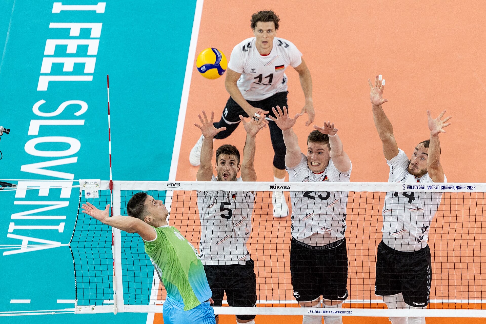 Players competing at the net in a volleyball match